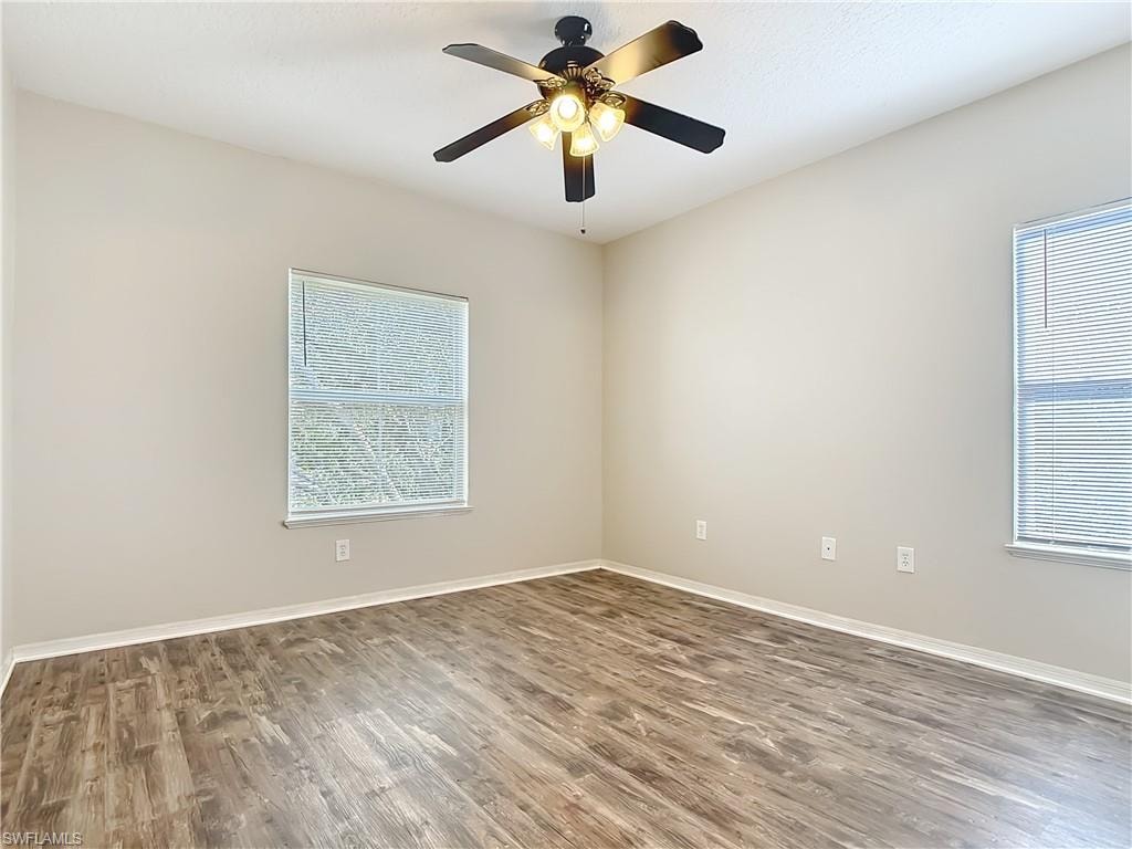 Spare room with wood finished floors and a ceiling fan