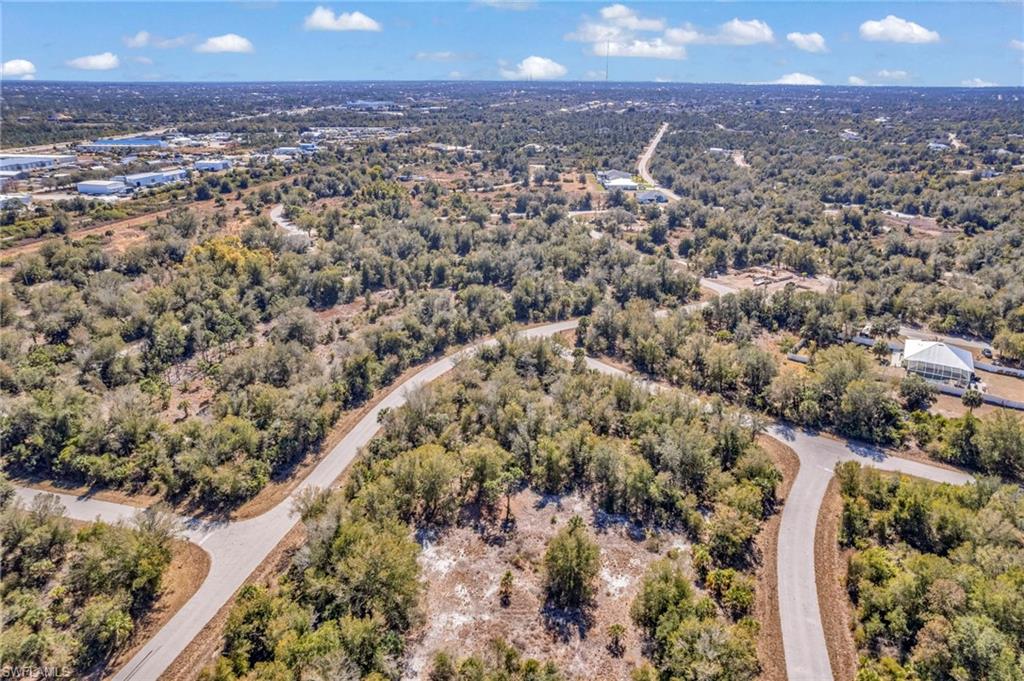 Aerial view of property's location featuring a heavily wooded area