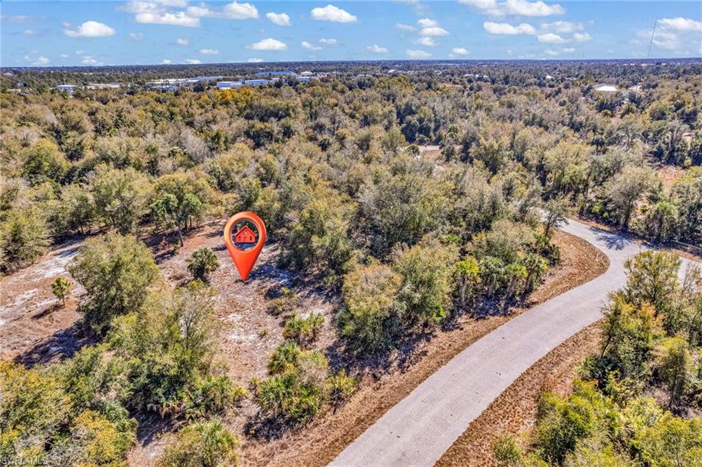 Aerial view of property's location featuring a forest