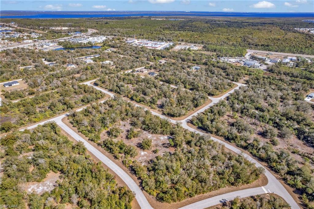 Aerial view of property and surrounding area with a heavily wooded area
