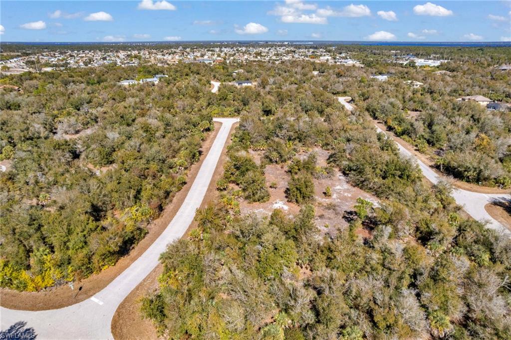 Aerial view of property's location featuring a forest