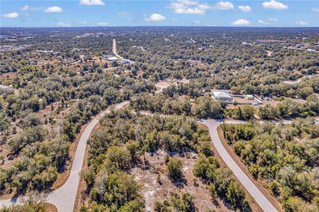 Aerial overview of property's location featuring a heavily wooded area