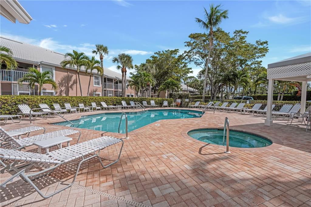 Community pool with a patio and a community hot tub