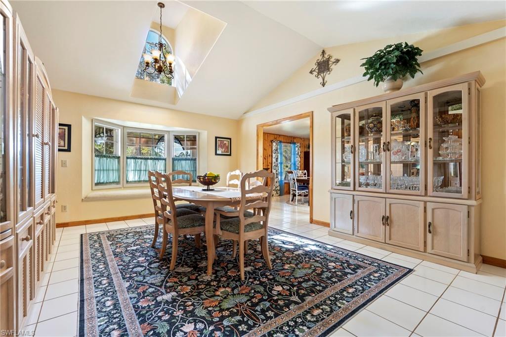 Dining space with light tile patterned floors and a chandelier