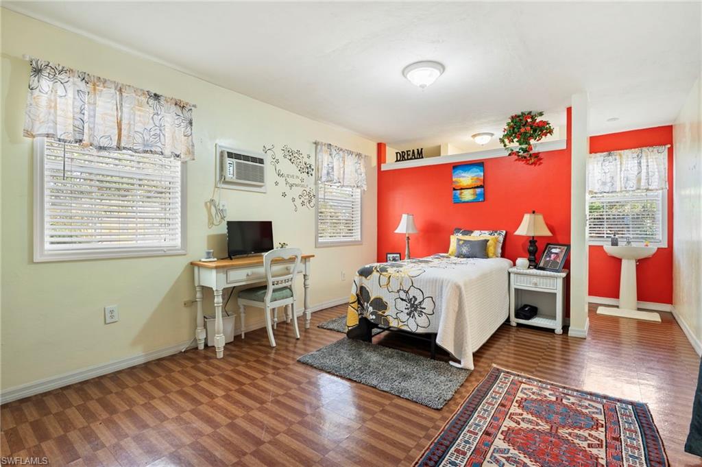 Bedroom featuring a wall unit AC and tile patterned floors