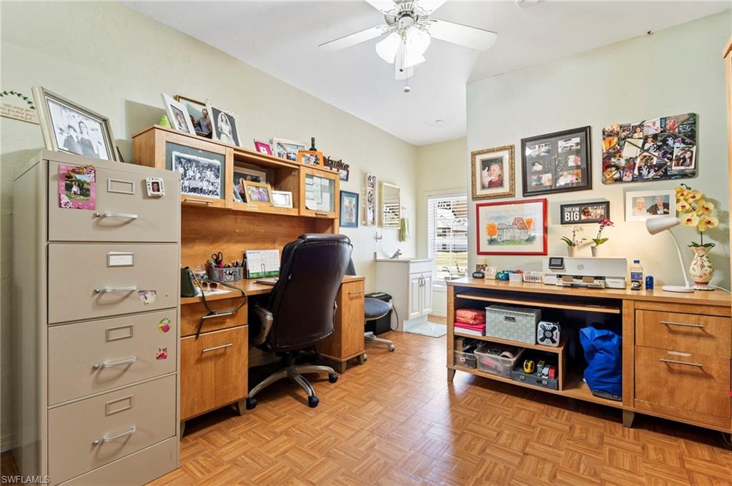Office with parquet floors and ceiling fan