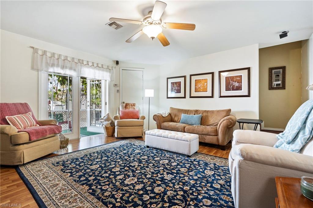 Living room with wood finished floors and ceiling fan