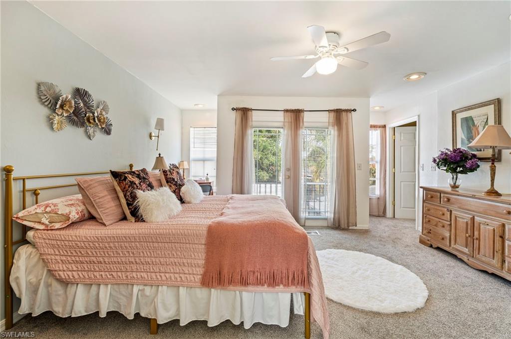 Bedroom featuring light colored carpet, access to outside, and ceiling fan