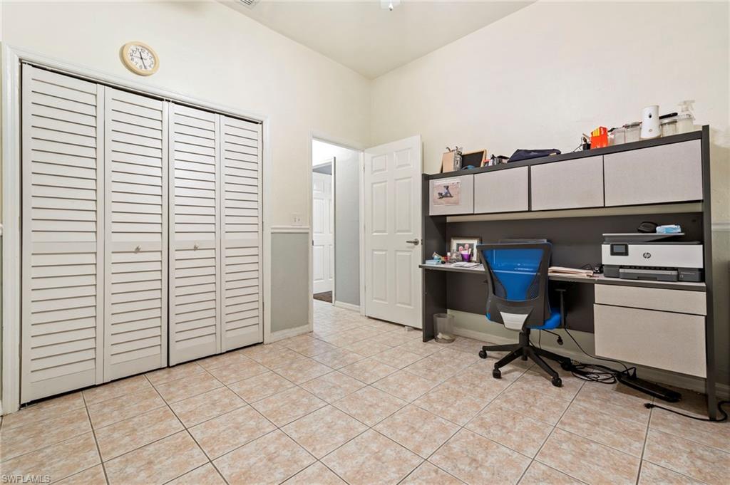 Office featuring baseboards and light tile patterned flooring