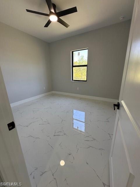 Unfurnished room with light marble finish flooring and ceiling fan