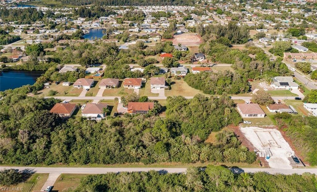 Aerial perspective of suburban area with a nearby body of water