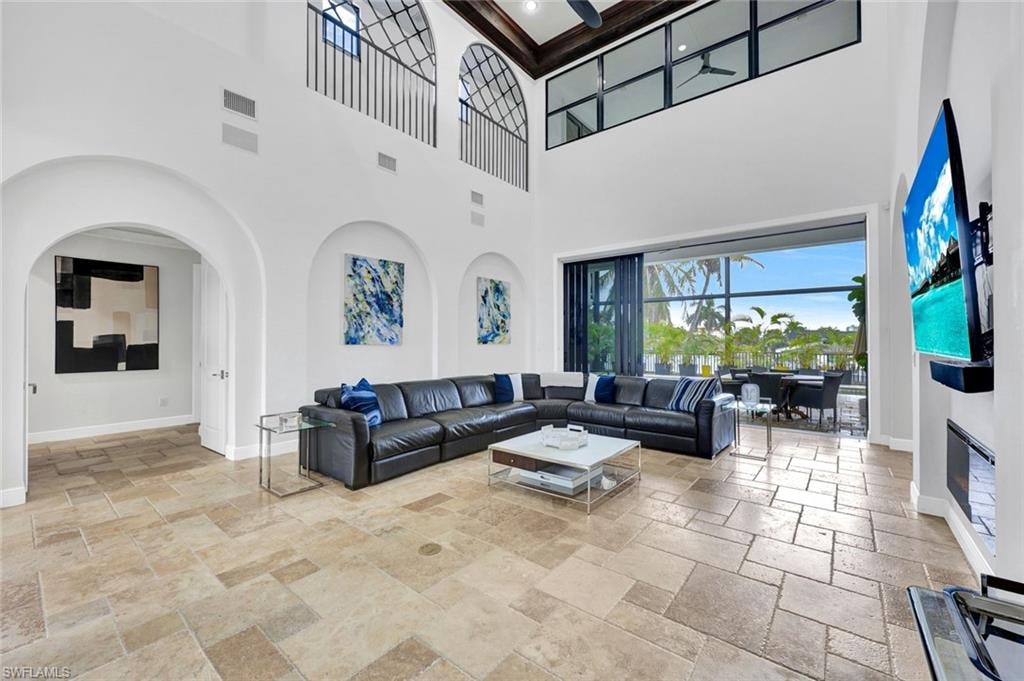 Living area with stone tile flooring and arched walkways