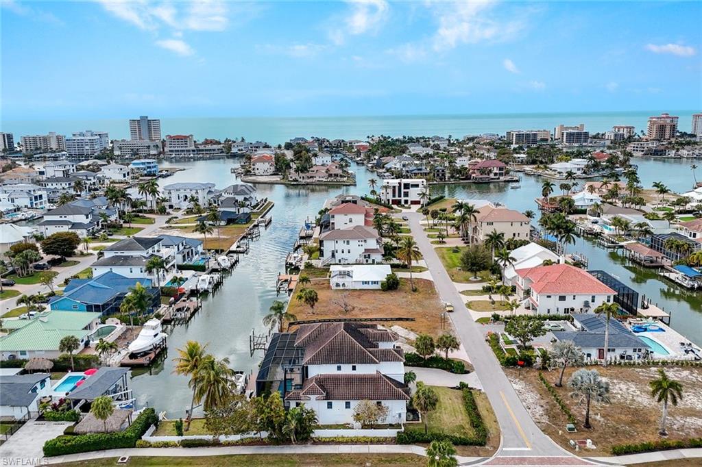 Aerial perspective of suburban area featuring a large body of water