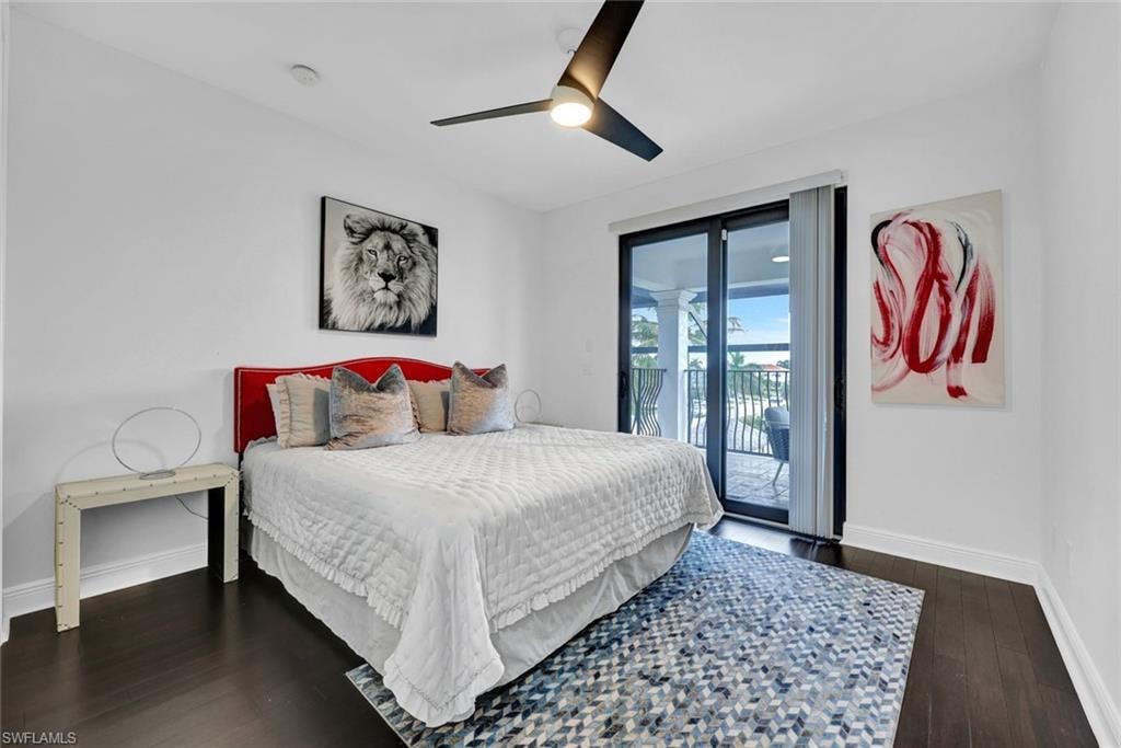Bedroom featuring access to exterior, dark wood-style floors, and a ceiling fan