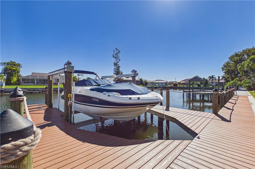 Dock featuring boat lift and a water view