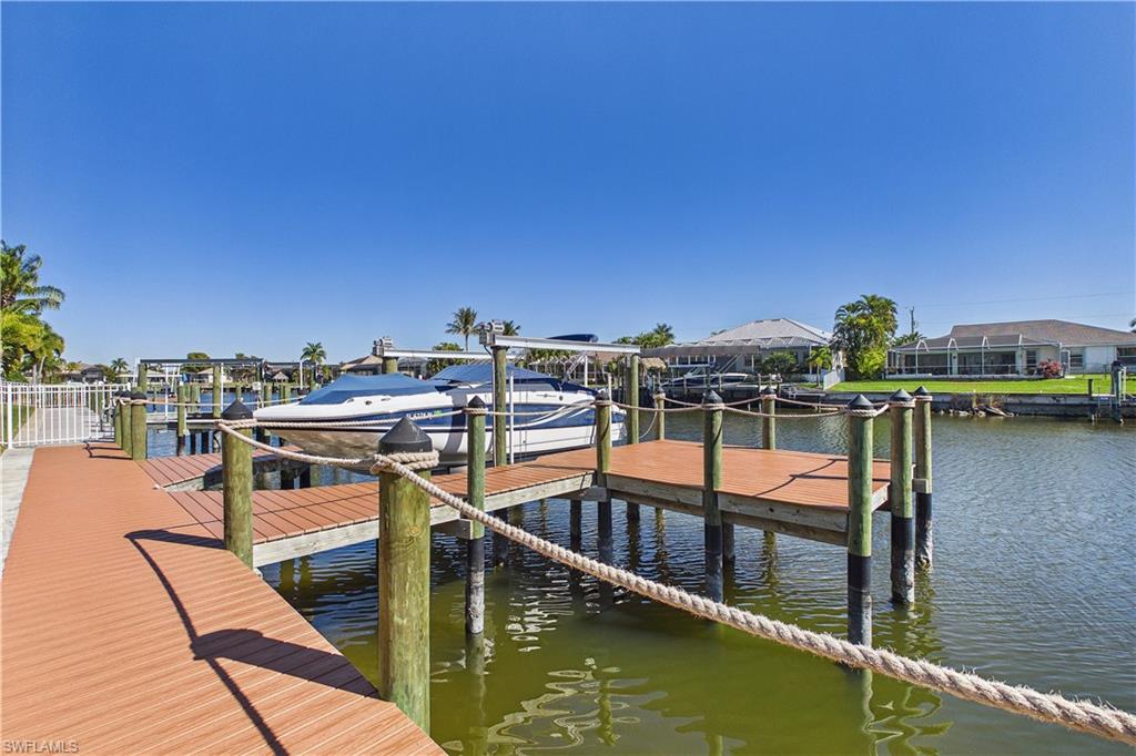 Dock area featuring boat lift and a water view