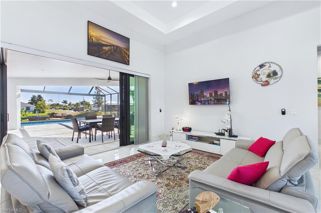 Living room with a sunroom and a high ceiling