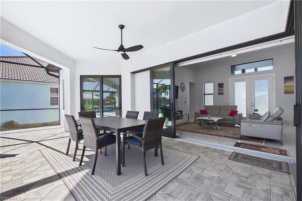 Dining space with french doors, a ceiling fan, and a sunroom