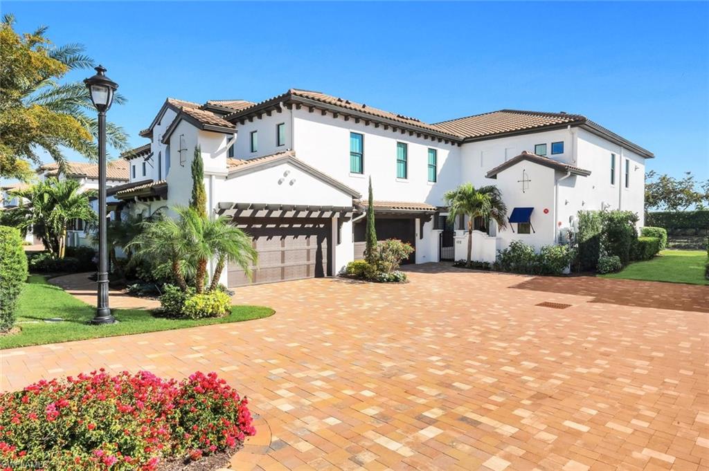 Mediterranean / spanish-style home with stucco siding, an attached garage, and driveway