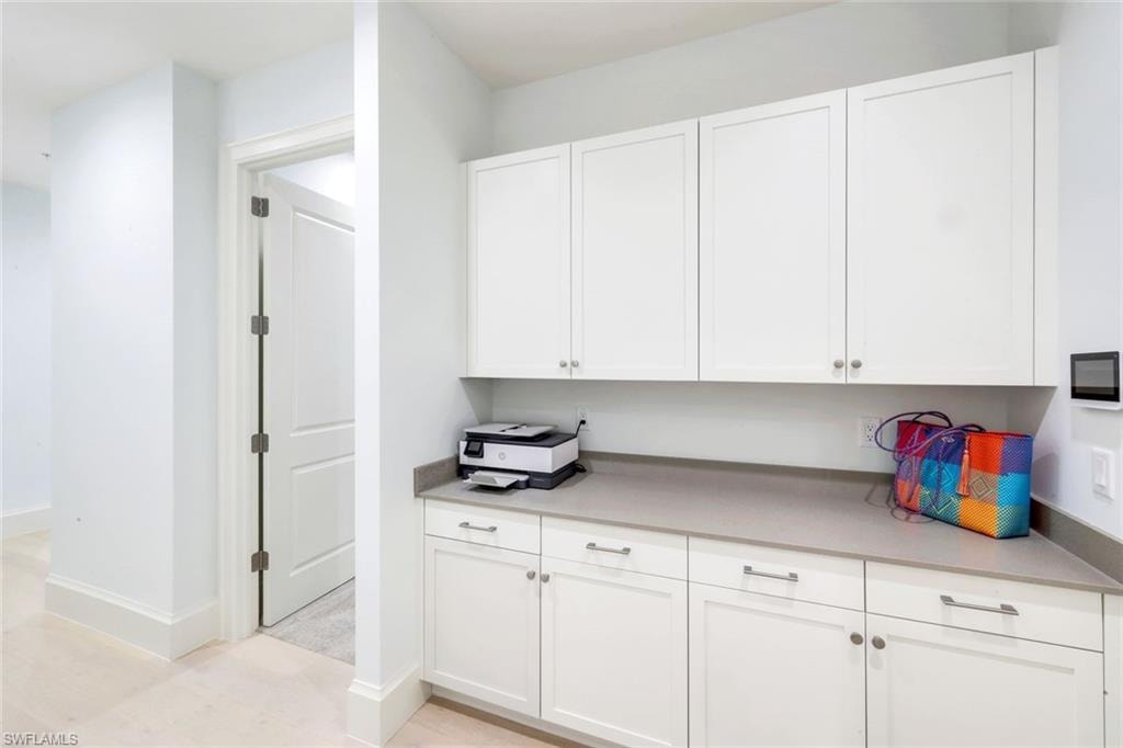 Kitchen featuring white cabinetry and baseboards