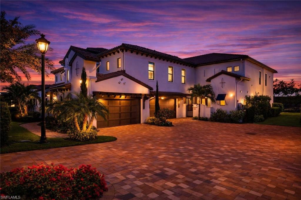 Mediterranean / spanish-style house with a garage, stucco siding, decorative driveway, and a tiled roof