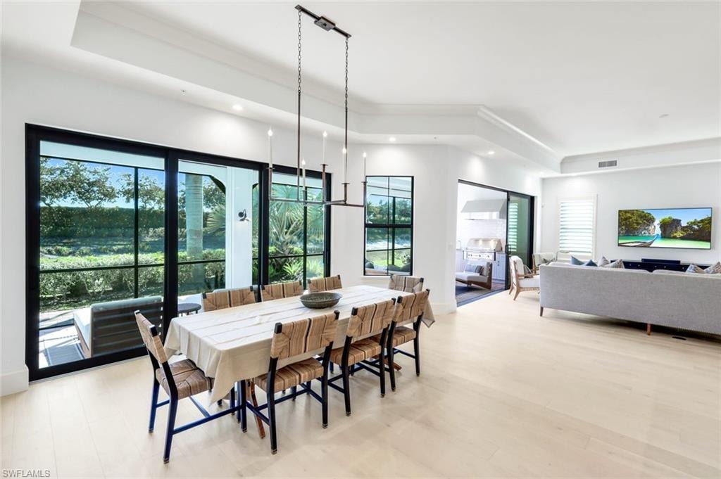 Dining room with recessed lighting and a raised ceiling
