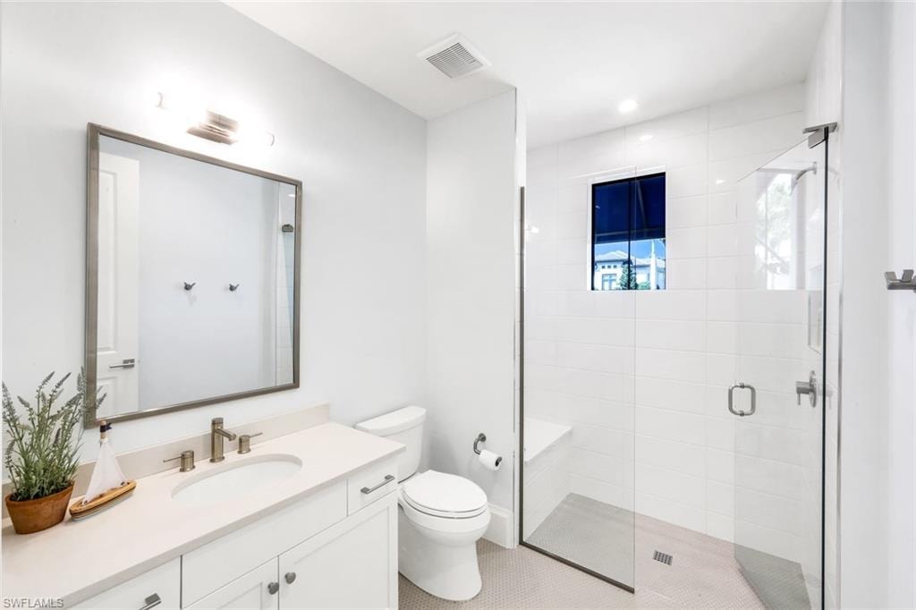 Full bath with vanity and a stall shower