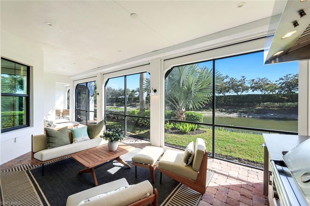 Sunroom featuring a water view