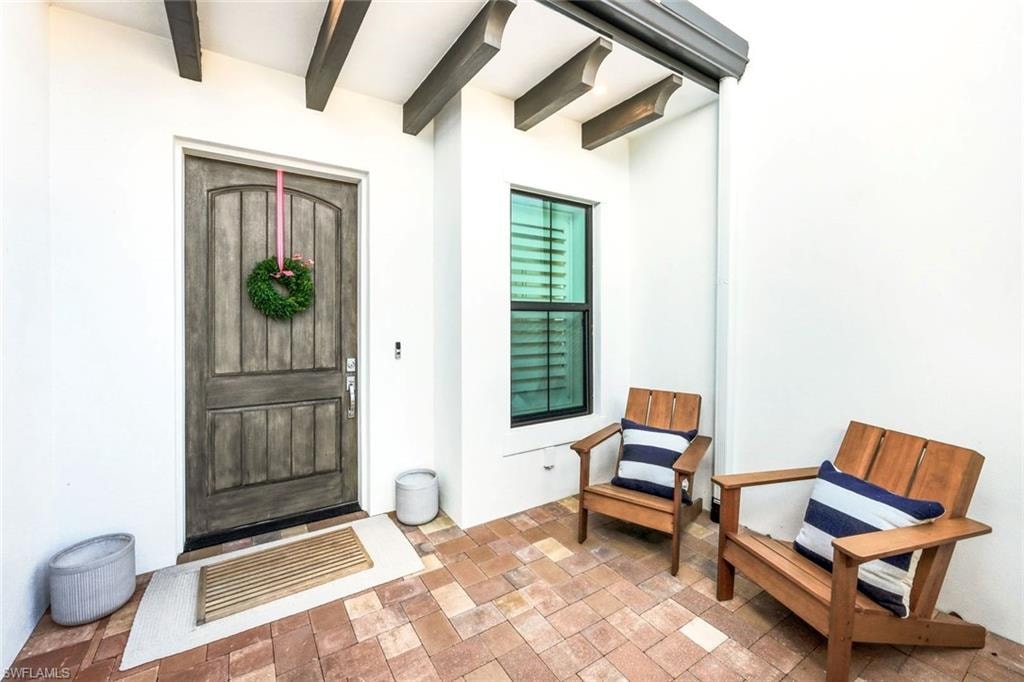 View of exterior entry with stucco siding