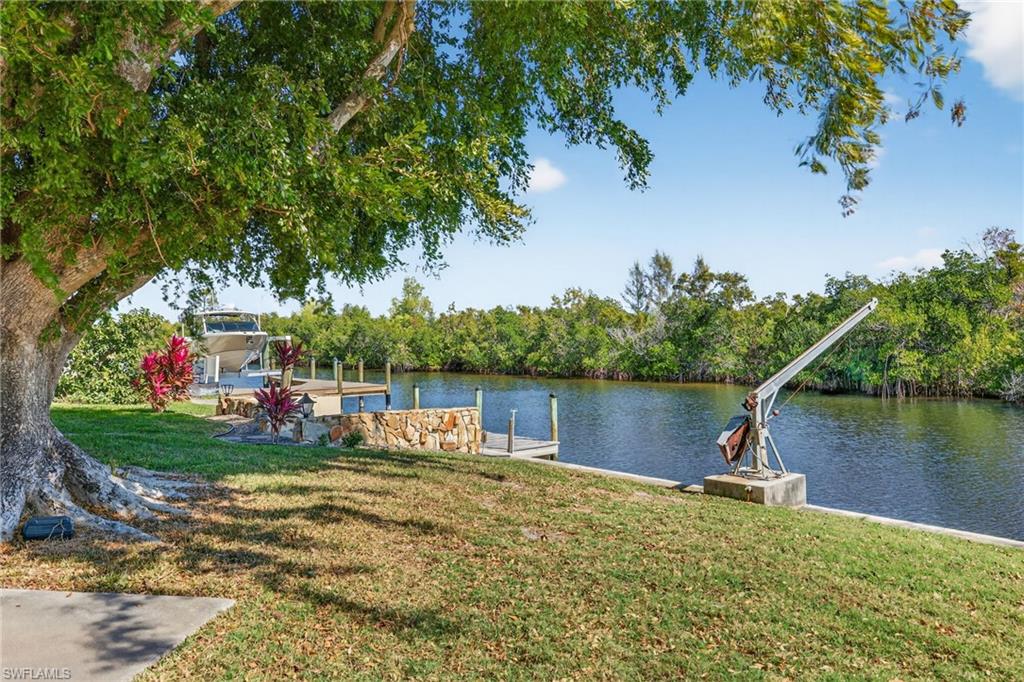 Dock with a lawn and a water view