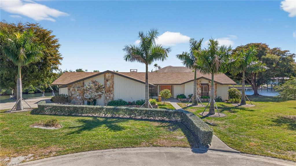 Ranch-style house featuring a front lawn