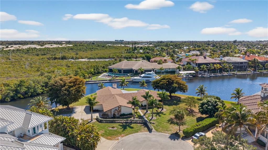 Aerial view of residential area featuring a nearby body of water