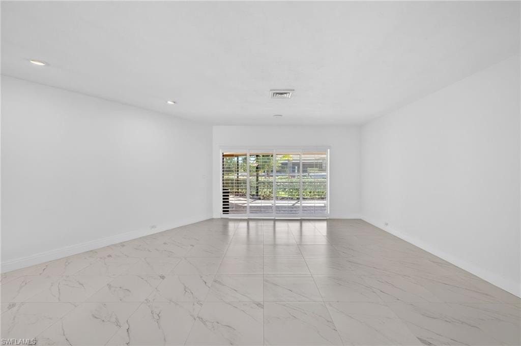 Spare room with light marble finish flooring
