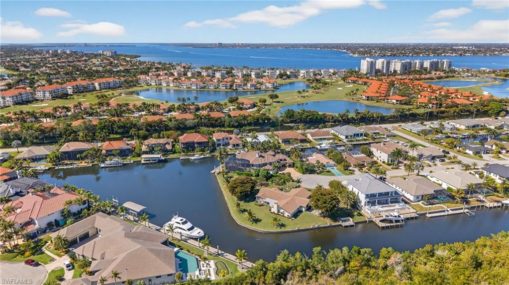 Aerial perspective of suburban area featuring a large body of water
