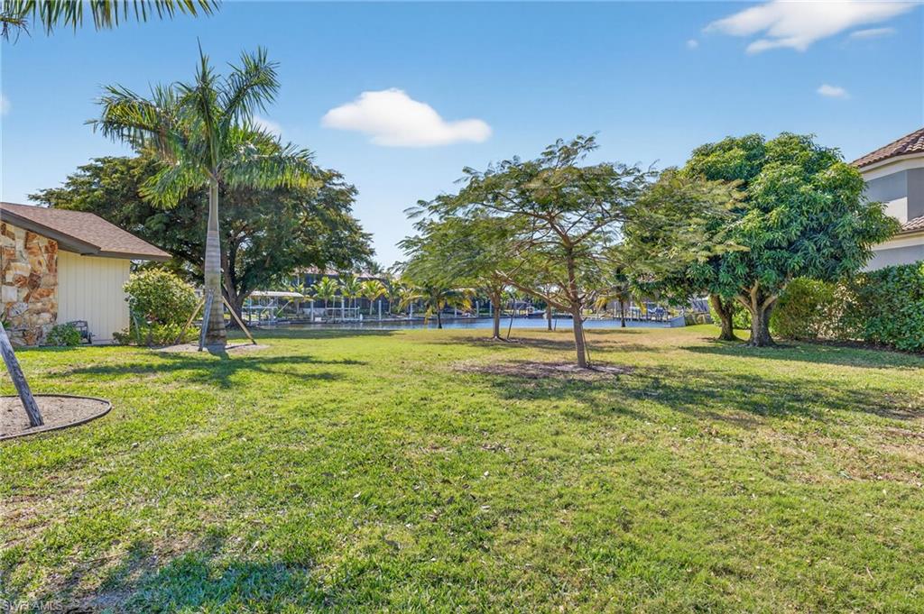 View of grassy yard with a water view