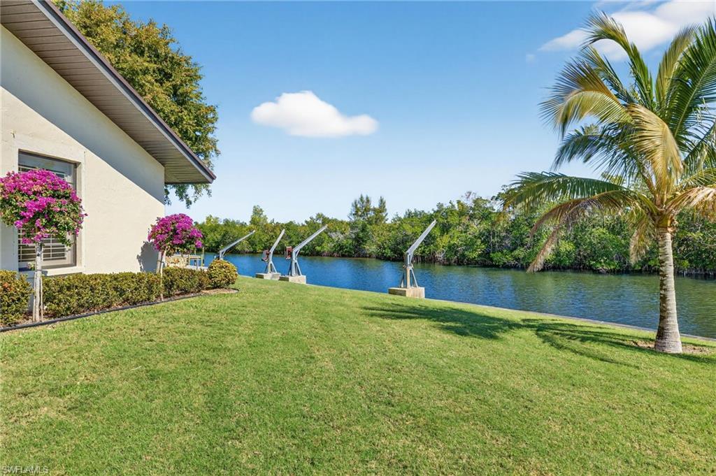 View of green lawn with a water view
