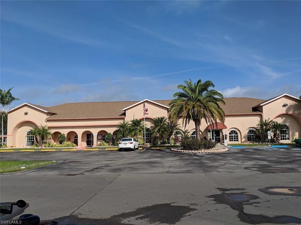 View of building exterior featuring uncovered parking