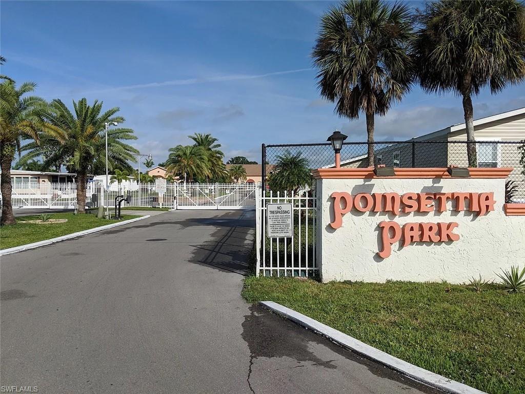 Community / neighborhood sign featuring a gate