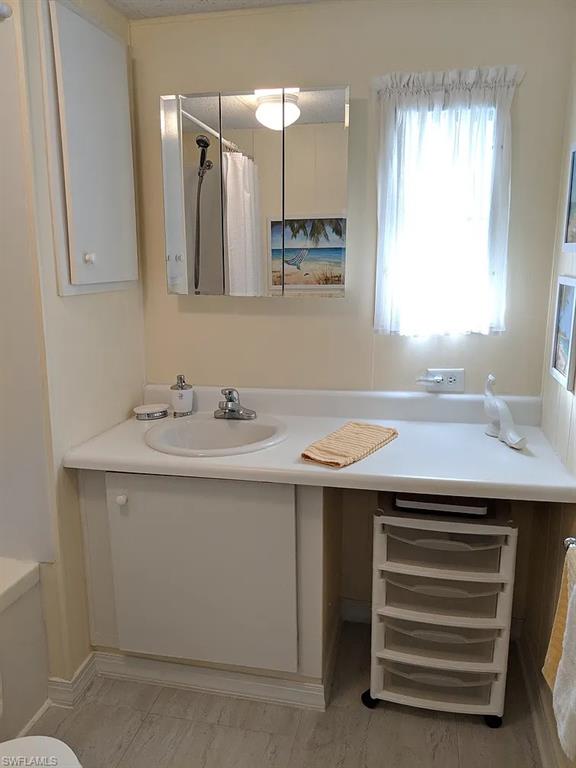 Full bath with vanity and curtained shower
