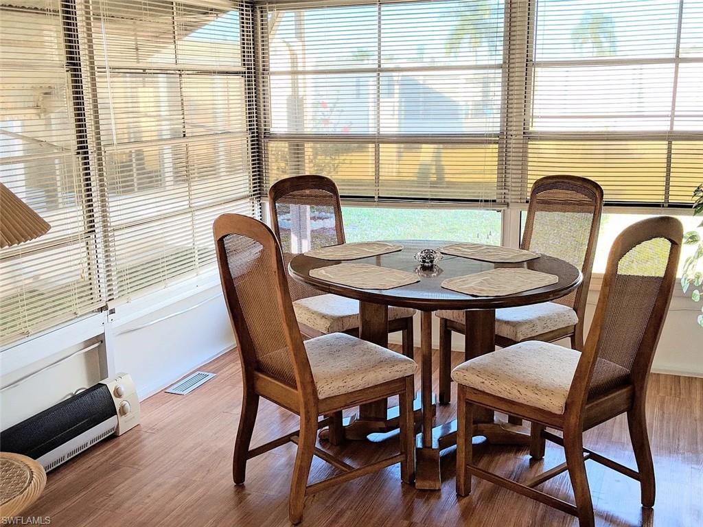 Dining area with wood finished floors and healthy amount of natural light
