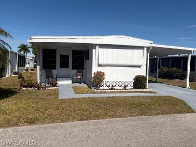 View of front of home with a carport, a front lawn, driveway, and covered porch
