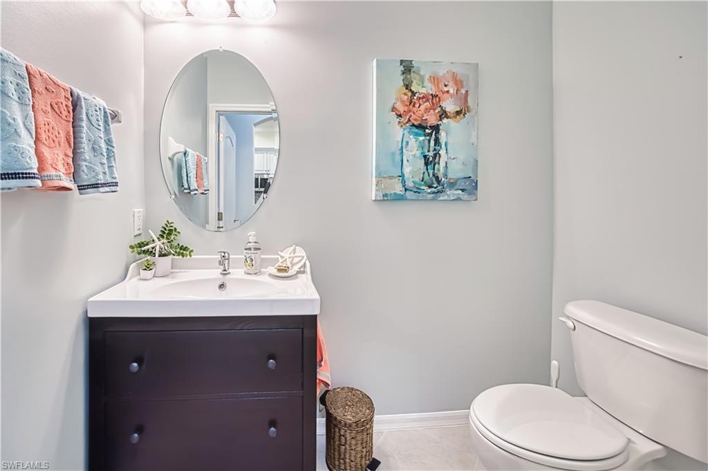 Half bathroom with vanity and tile patterned floors