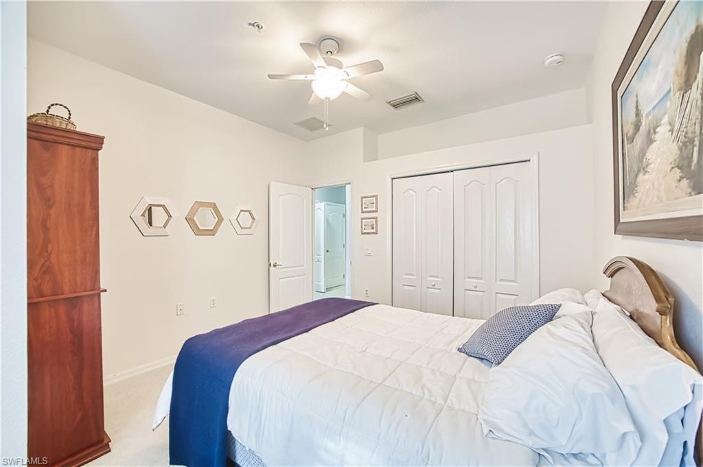 Bedroom with a ceiling fan, carpet, and a closet