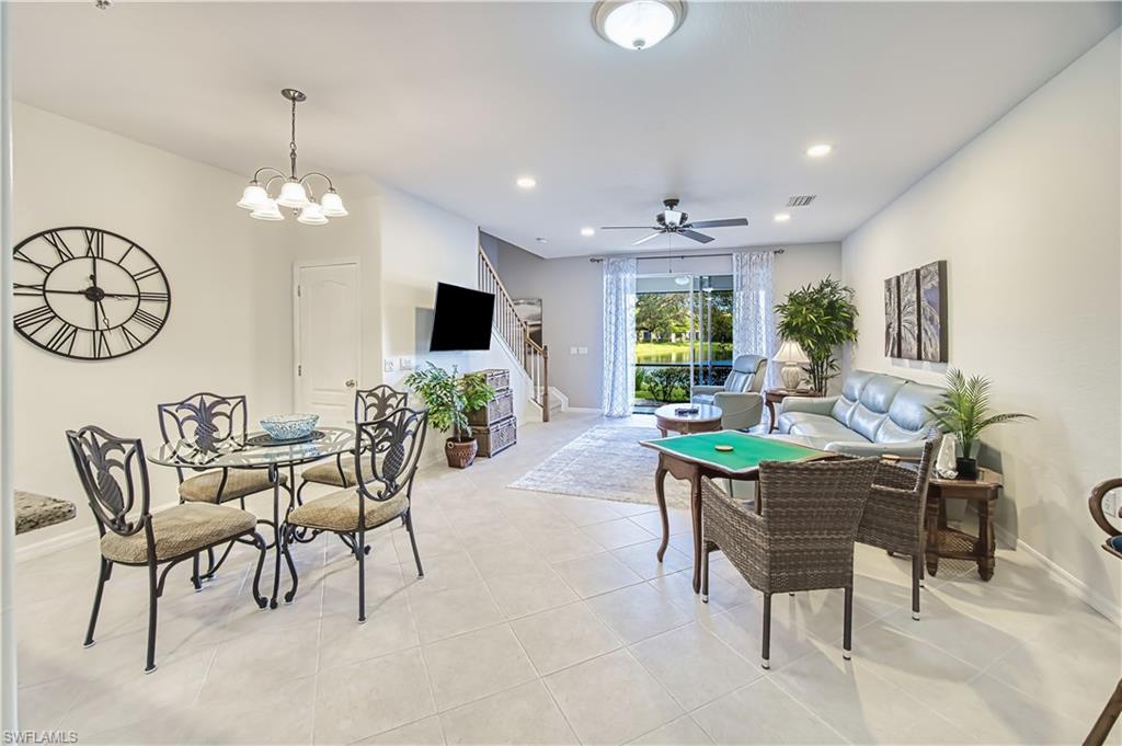 Dining area with ceiling fan, a chandelier, and light tile patterned floors