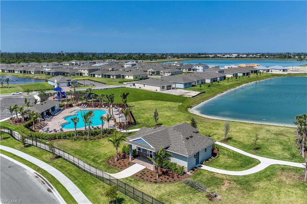 Community amenities featuring a resort-style pool, clubhouse, and playground with expansive green spaces and waterfront properties