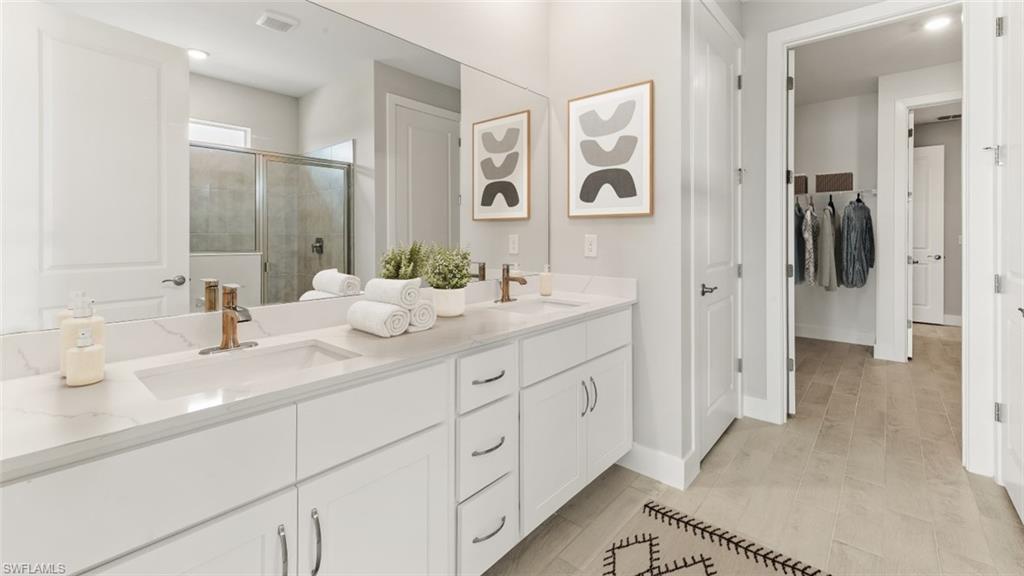 Dual white vanities with integrated sinks and bronze-finish fixtures