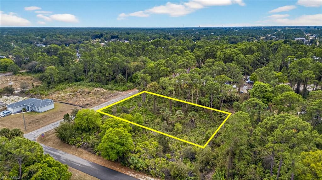 View of property location featuring property boundaries highlighted and a heavily wooded area