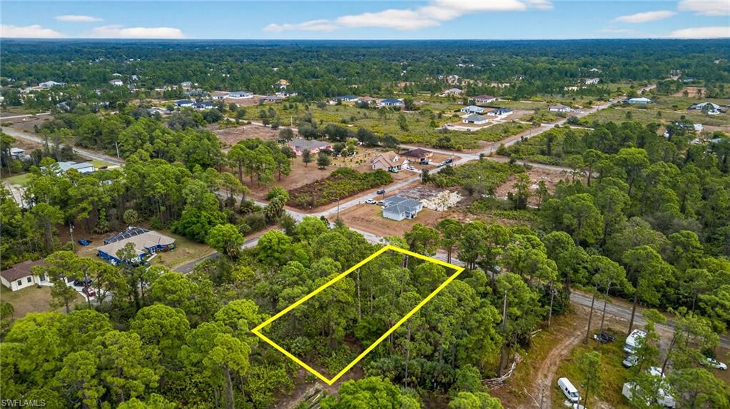 View of property location with property parcel outlined and a heavily wooded area