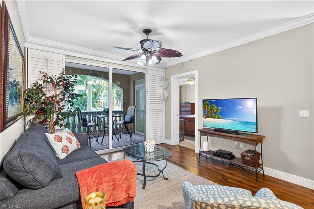 Living area with ornamental molding, hardwood / wood-style floors, and a ceiling fan