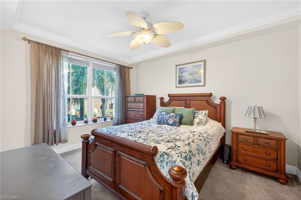 Bedroom featuring carpet floors, a ceiling fan, and crown molding
